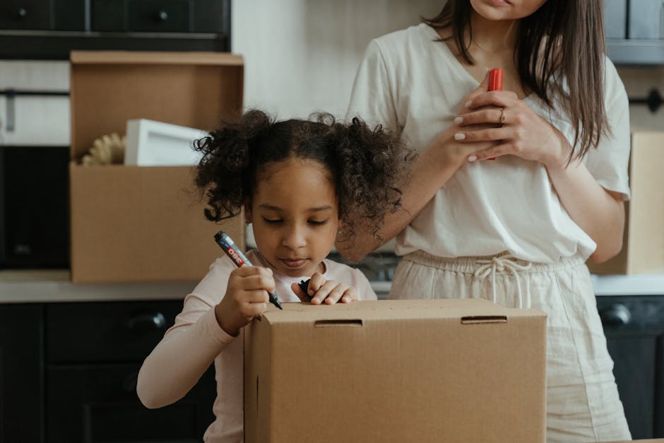 A mother and her daughter pack boxes while moving into their new home, embracing family life.