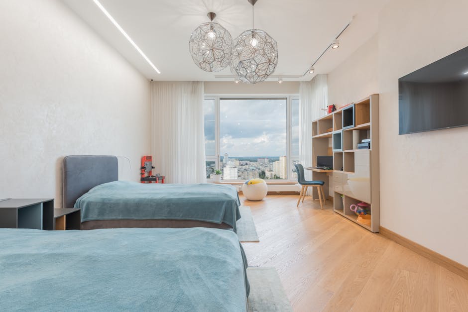 Spacious modern bedroom with twin beds and city view through large window.