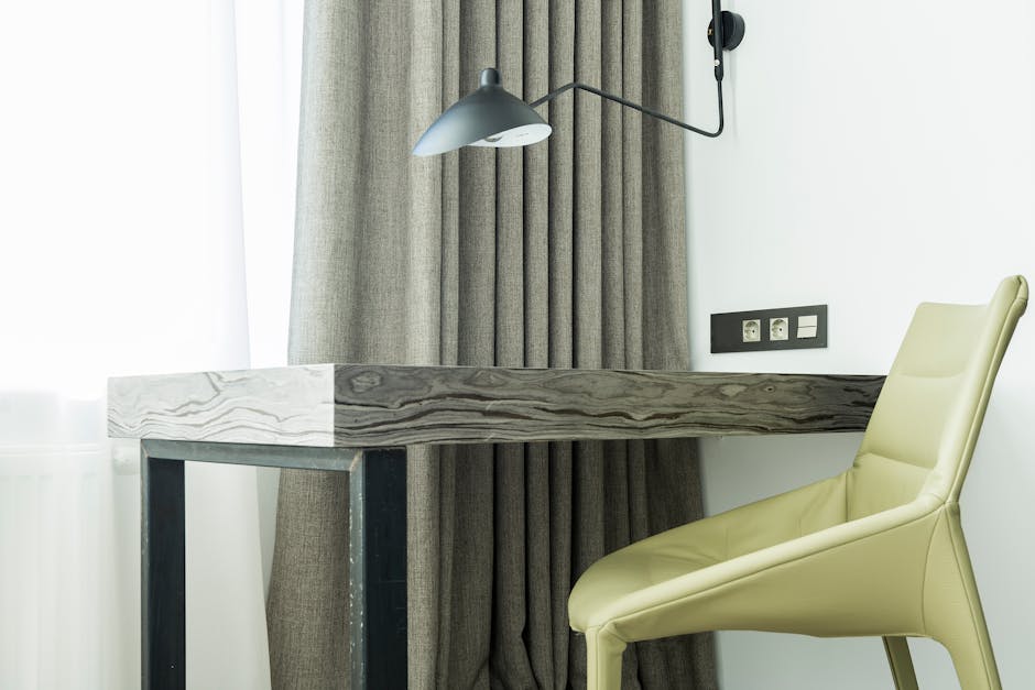 A cozy and contemporary workspace featuring a wooden desk and stylish chair, perfect for home offices.