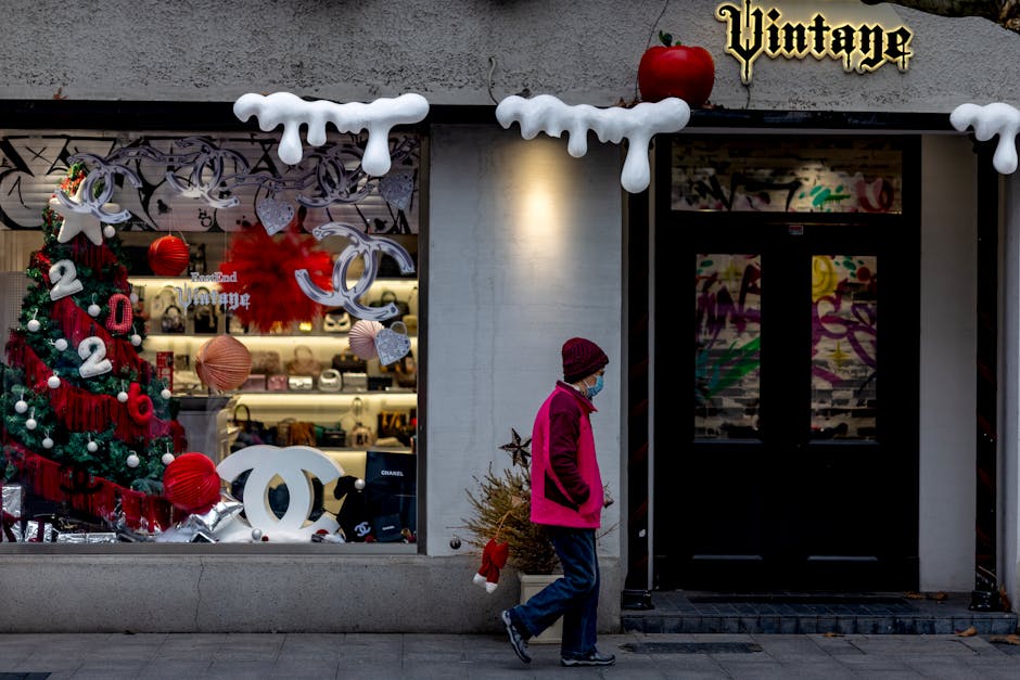 A street scene featuring a festive Christmas display with a passing pedestrian.