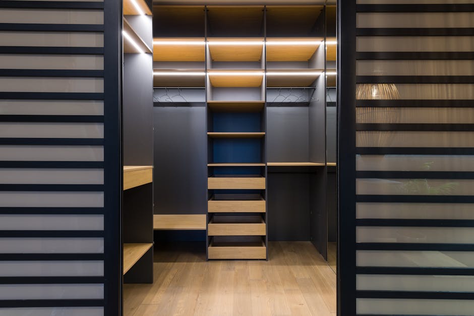 Spacious luxury walk-in closet with modern wooden shelving and stylish lighting.