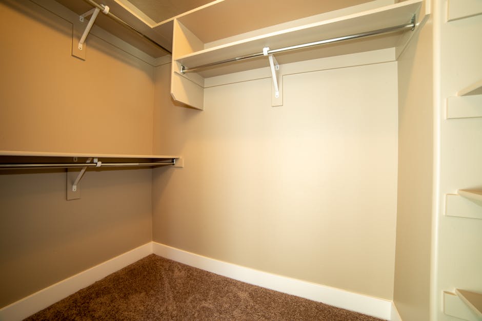 Modern walk-in closet with ample storage and neutral tones.
