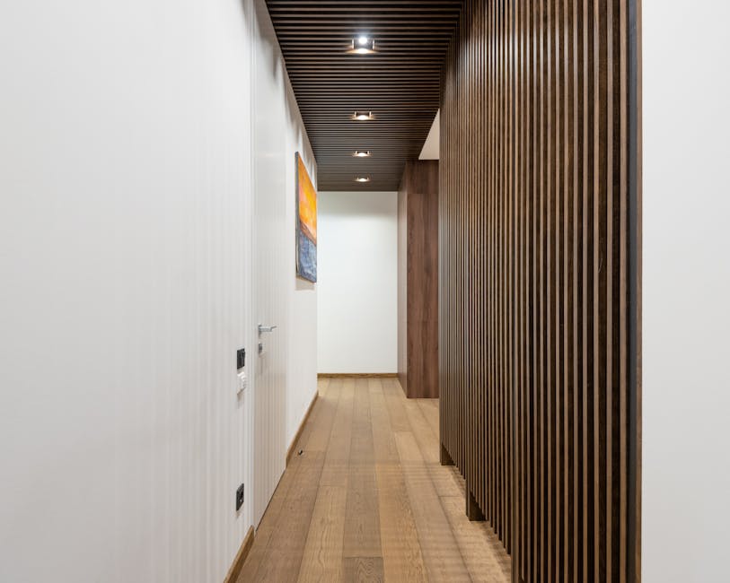 A sleek, contemporary hallway featuring wood paneling and modern lighting fixtures.