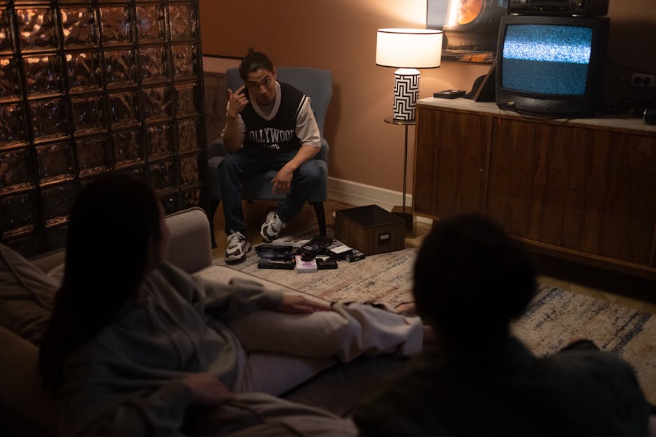 Three friends relax in a cozy room, watching TV together for a movie night.