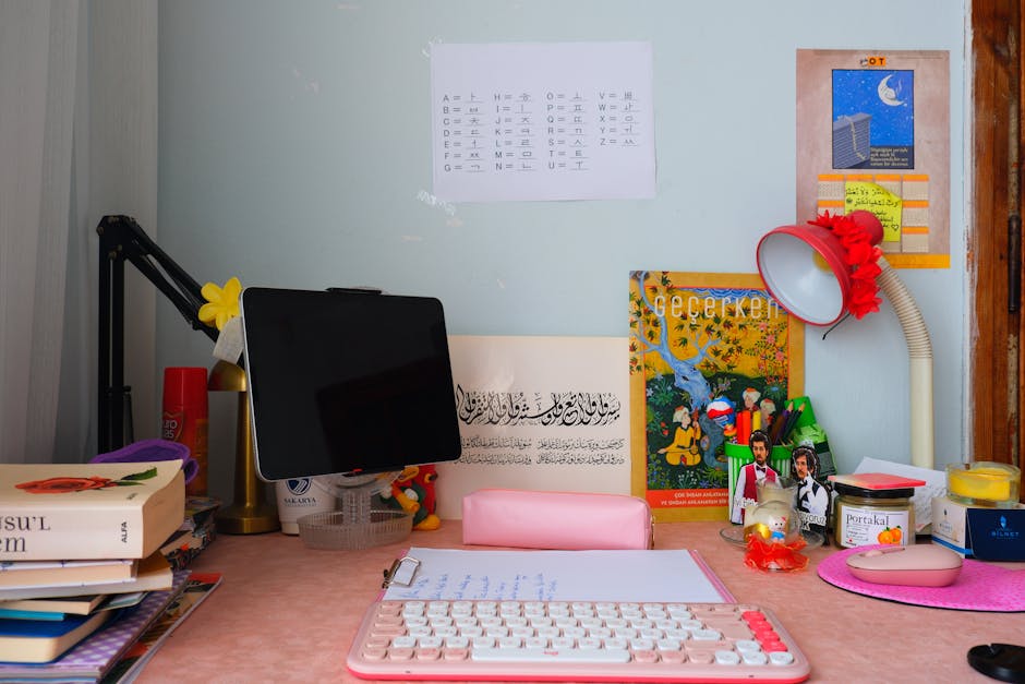 A colorful and organized study desk with books, a keyboard, and a tablet, perfect for creativity and learning.