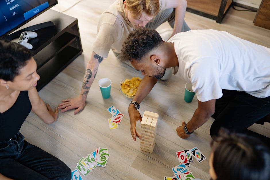 Group of friends enjoying board and card games in a cozy home setting.