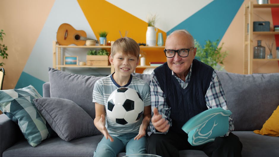 Grandfather and grandson enjoy playtime indoors with a soccer ball.