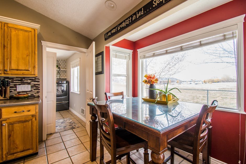 Inviting kitchen interior with wooden cabinets and dining area overlooking a garden.