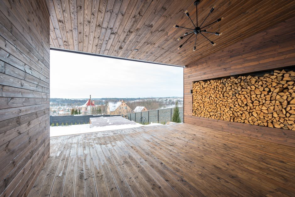 Spacious wooden interior with large firewood storage and outdoor view.