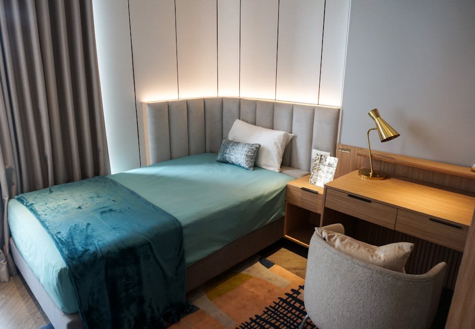 Chic modern bedroom featuring a single bed, wooden desk, and stylish decor.